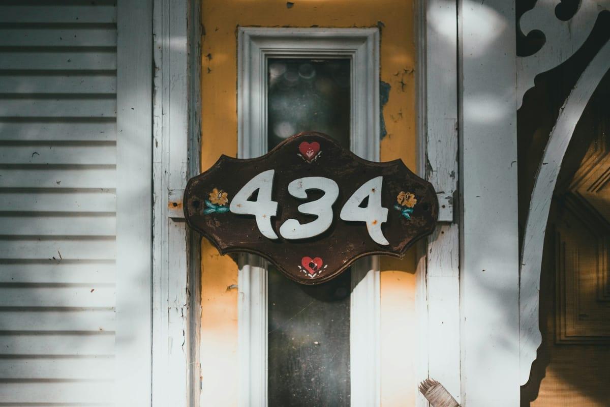 House facade with the house number pixelated — original